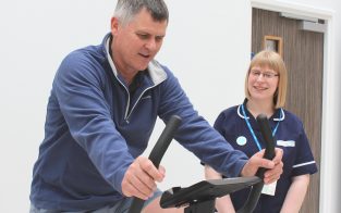 Visitor Steven Brown managed to cycle the furthest in two minutes during the exercise challenge. He's pictured with Research Nurse Heather Sanigar.